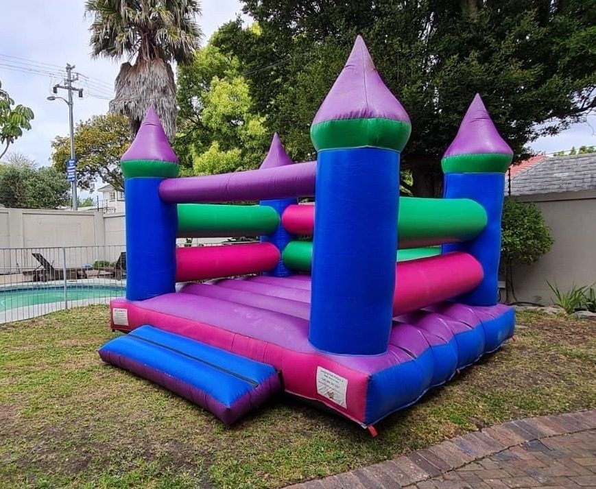 Outdoor pink, green and blue jumping castle