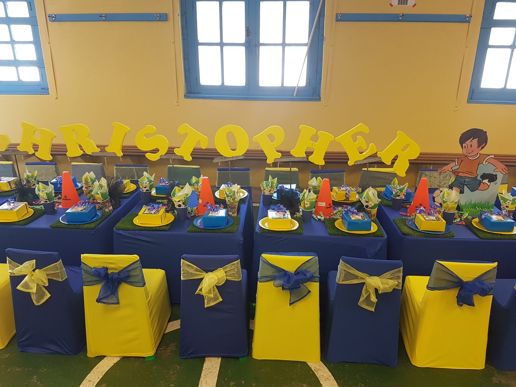 Boys theme party table with blue and yellow decor