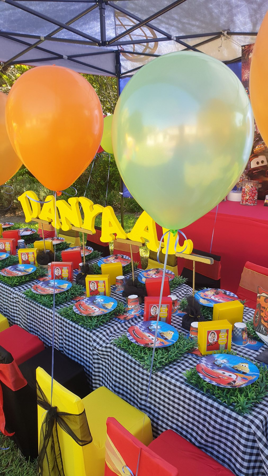 Outdoor mixed-colour character party table setup